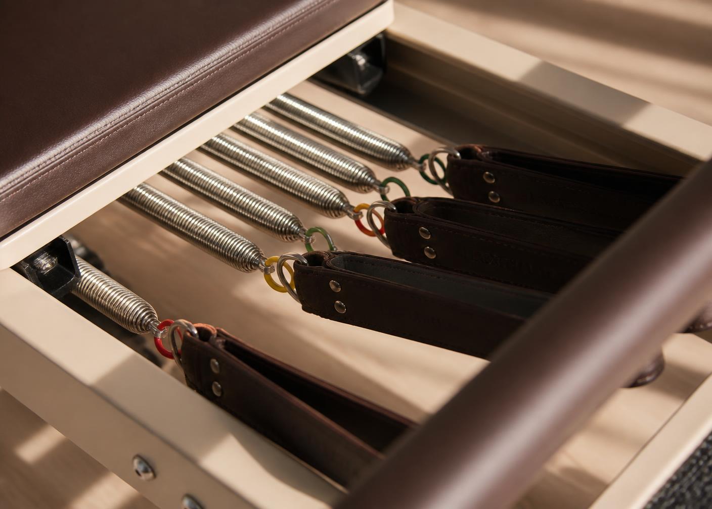 Close-up of reformer springs and leather straps